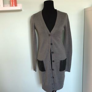 Grey cardigan with leather accent pockets.
